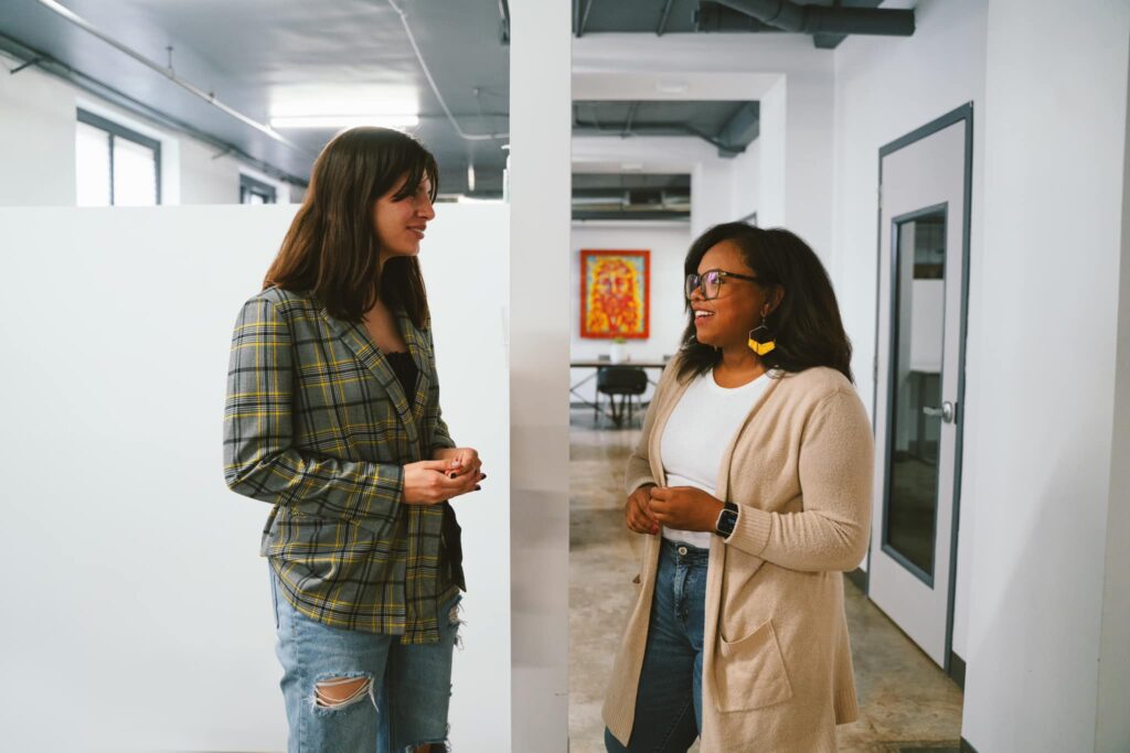 Alexis Revilla & Precious Martinez chatting in The Tadpole Agency office.